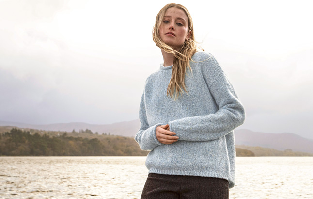 Frau im Pulli vor schottischem See